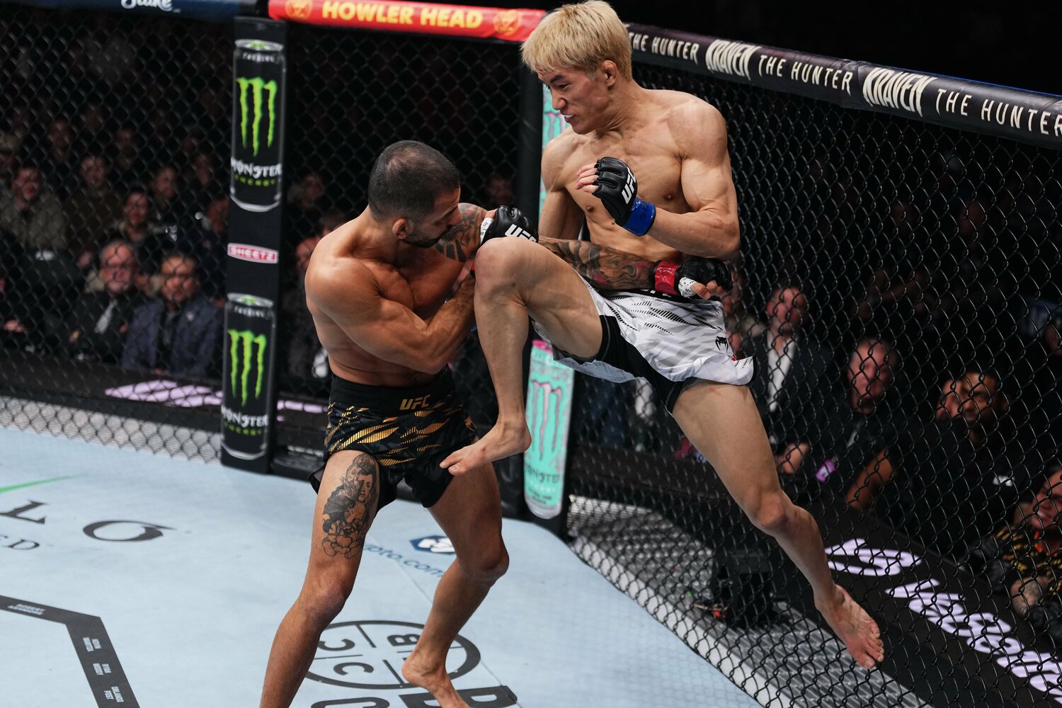 金網を背に飛びヒザを放つ朝倉海　©Getty Images